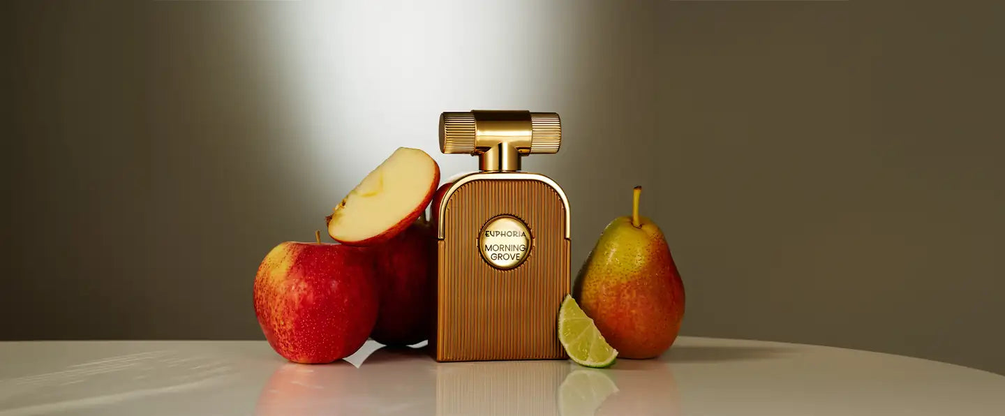 Morning Grove parfum bottle with red apples, a sliced apple, lime and a pear on a soft grey-olive background